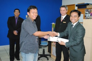 Director of Marcom Mohammad Iqbal presents a dining voucher to Zulkifli BJ, one of the lucky winners